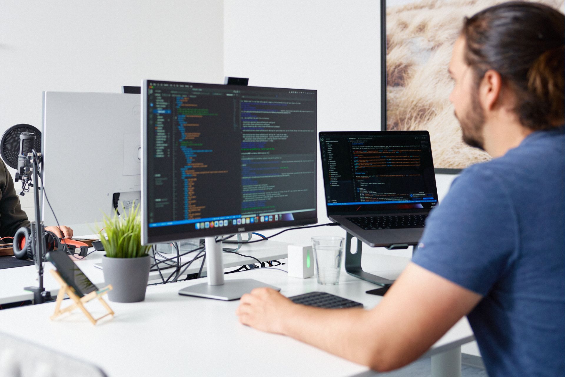 One 2wcom employee working and coding software on their Screens.